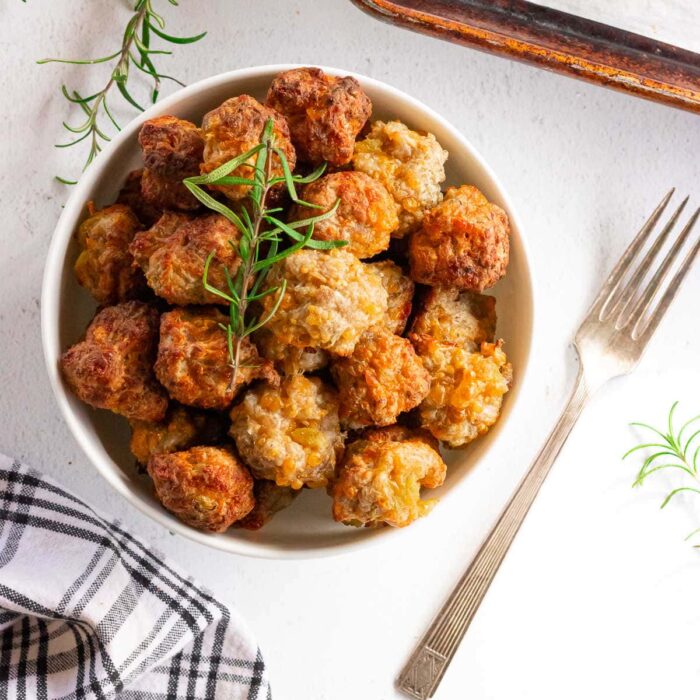 Overhead view of baked sausage balls in a bowl.