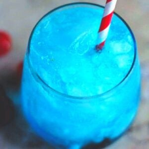 Blue cocktail with a red and white straw.