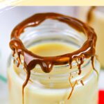 Closeup of a whiskey shot in a glass rimmed with chocolate.