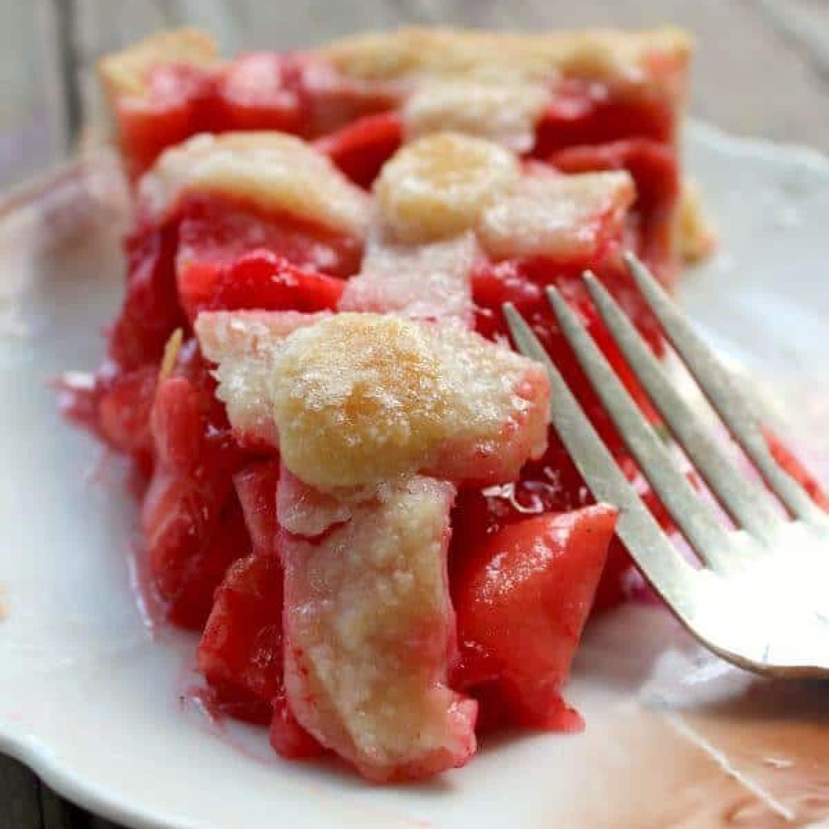 Close up of a slice of apple pie made with red hots candy.