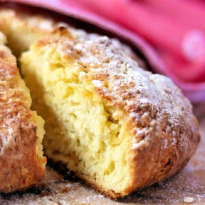 A slice of Irish soda bread being removed from the loaf.