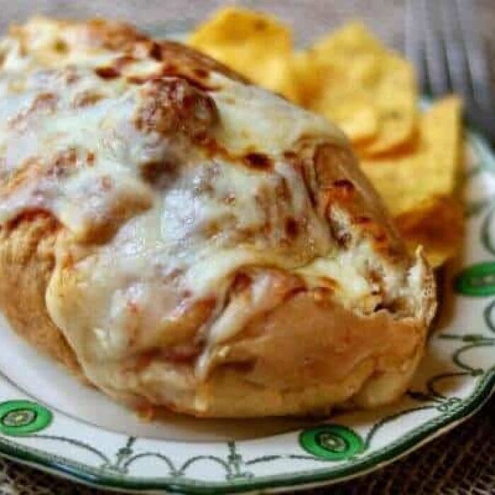 Meatball sandwich covered in melted Mozzarella cheese.
