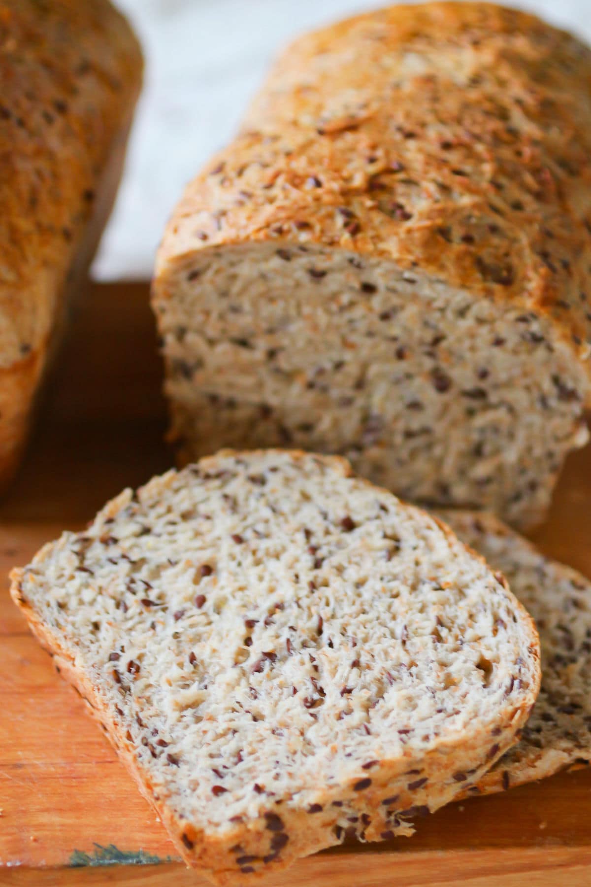 Multigrain bread sliced to show the internal texture with the flaxseeds.