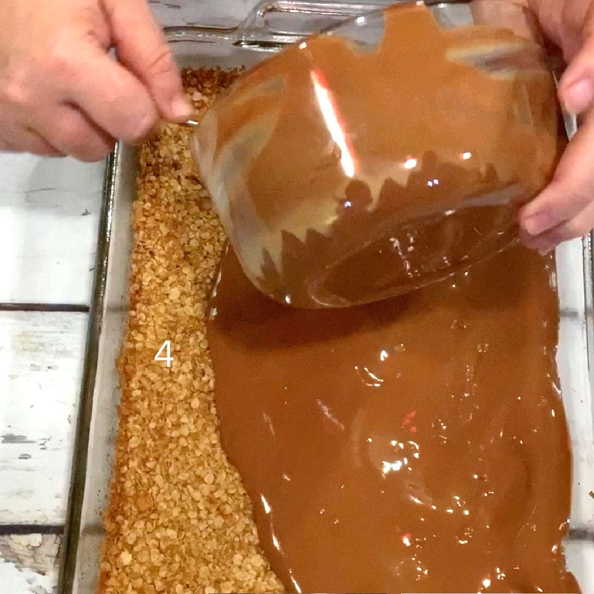 Pour melted chocolate and peanut butter onto the baked oatmeal layer.