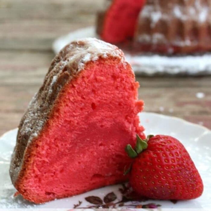 Close up of a slice of bright red strawberry pound cake.