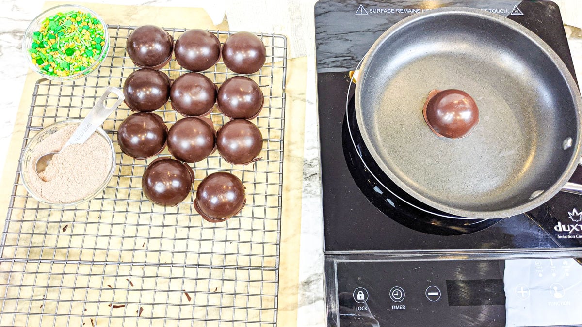 Warming the chocolate shells in a pan.