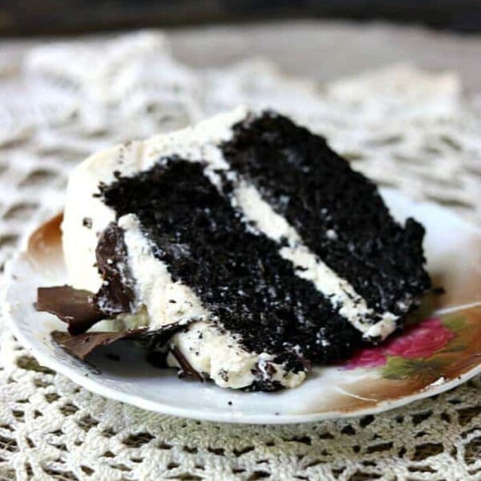 A slice of dark chocolate layer cake with Irish cream frosting.