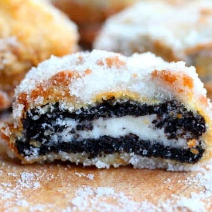 A battered and fried Oreo cut in half to show layers.