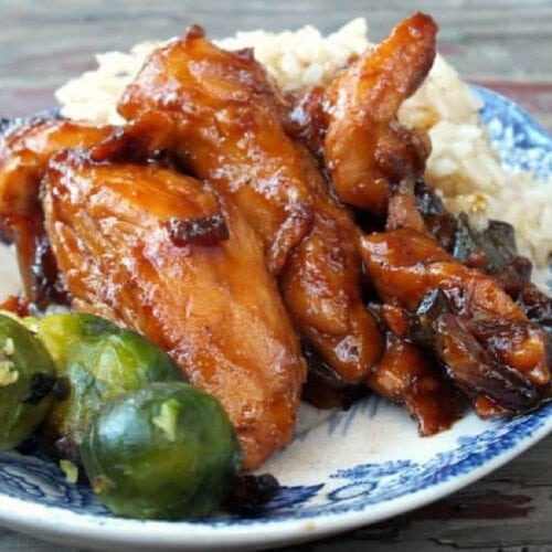 A plate of chicken glazed with a sticky sauce.