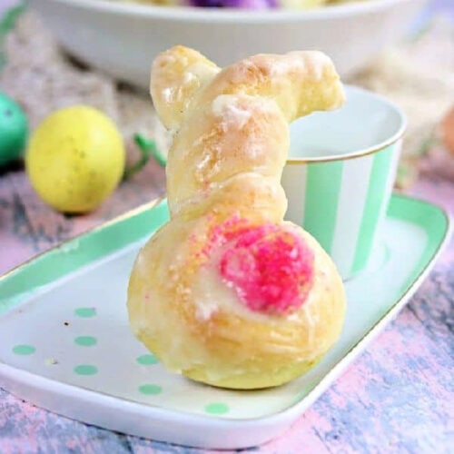 Orange sweet rolls shaped like an Easter bunny with a pink tail.