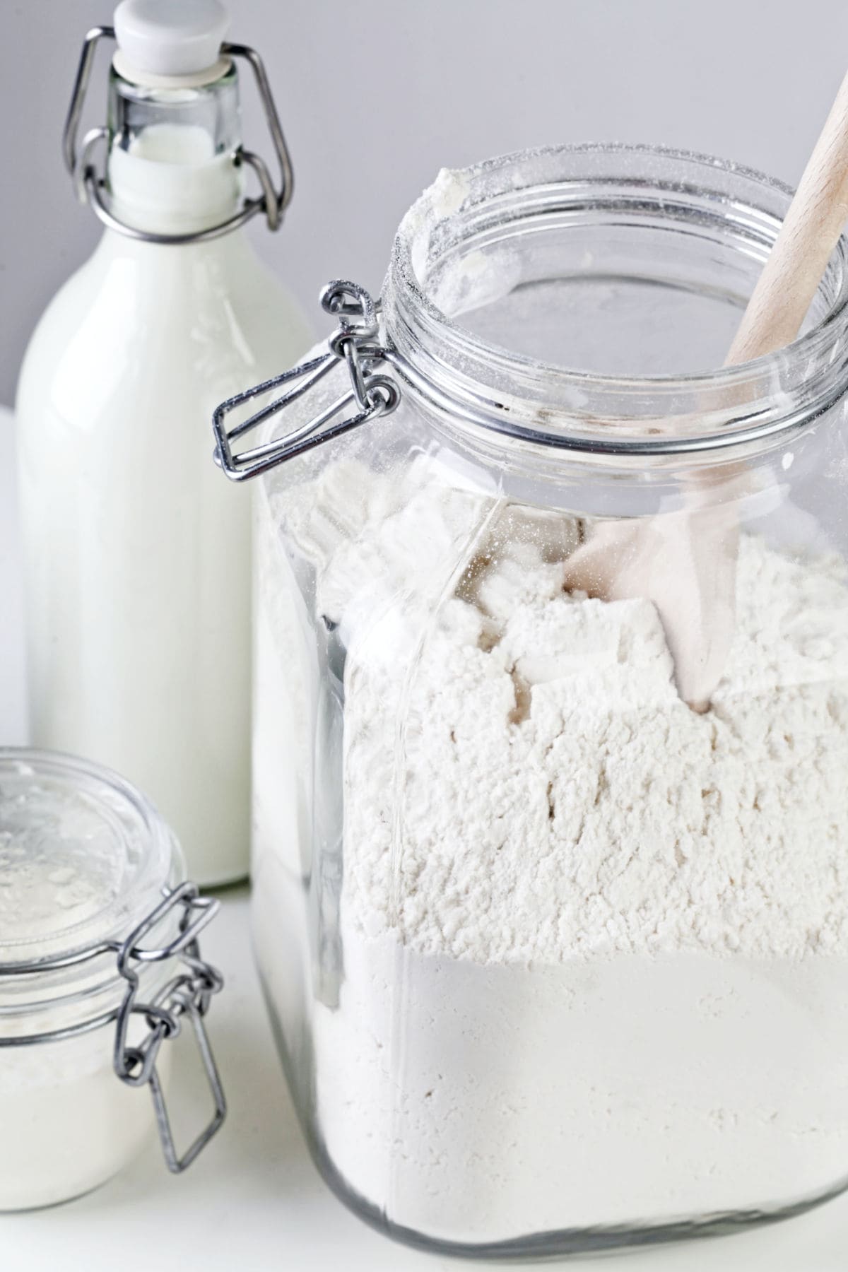 A glass canister filled with white flour.