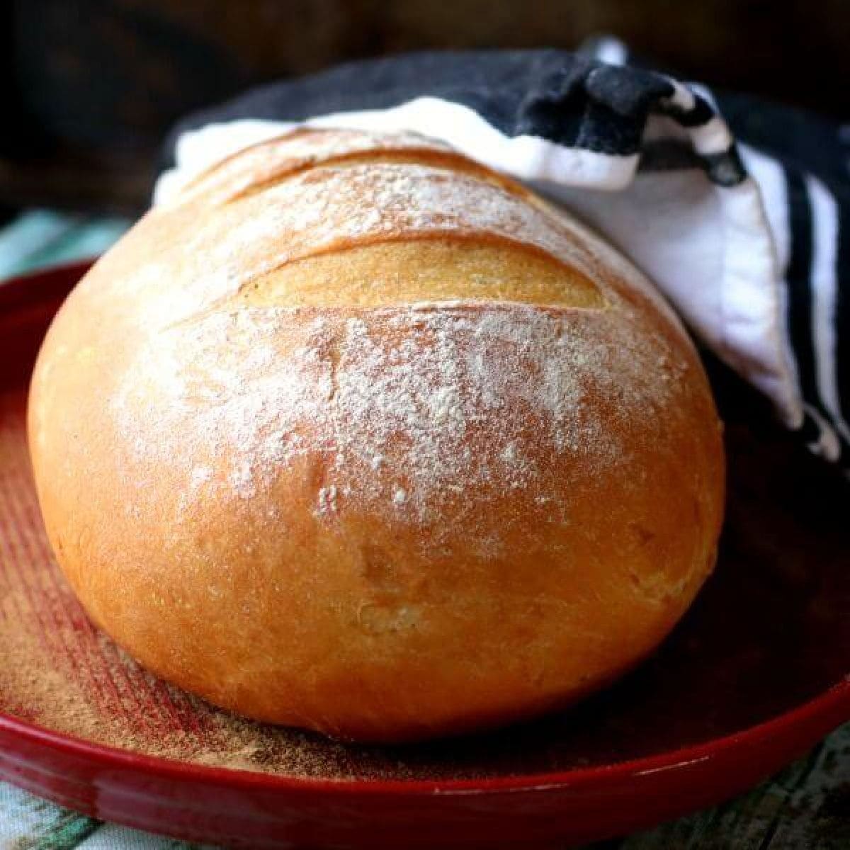 A round loaf of artisan bread on a cutting board.