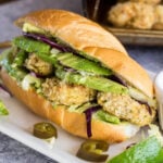 Close up of a shrimp sandwich with avocado.