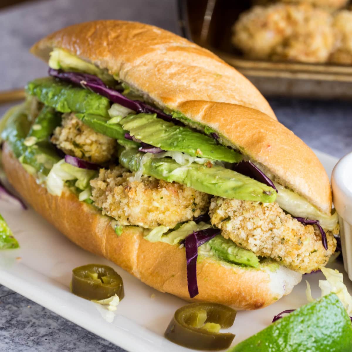 Close up of a shrimp sandwich with avocado.