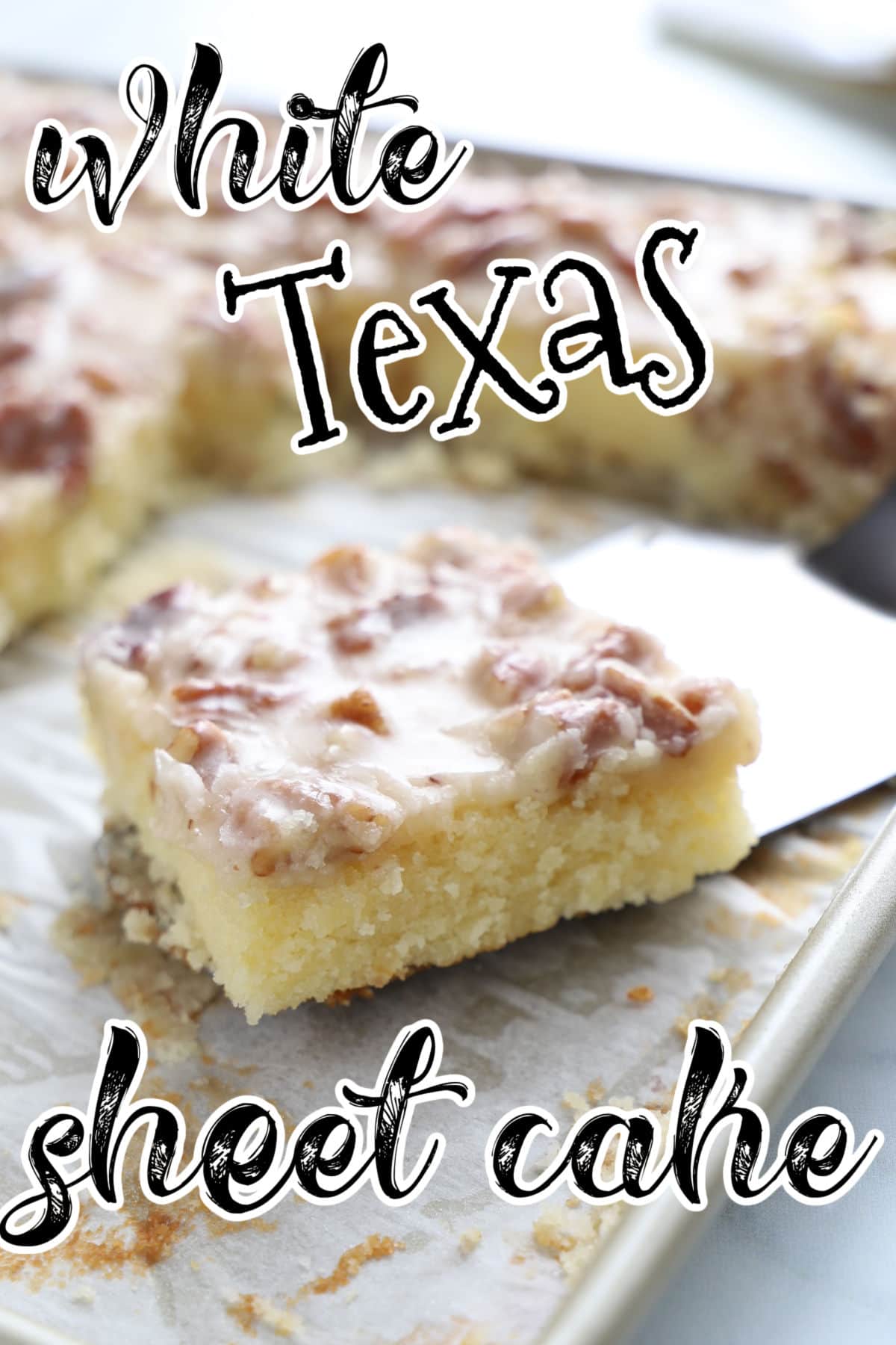 A square of white Texas sheet cake in a baking pan.