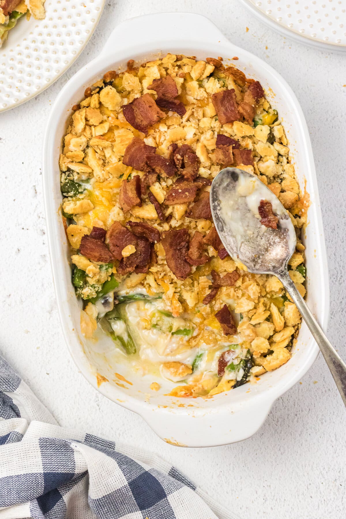 Overhead view of asparagus casserole with a serving spoon.