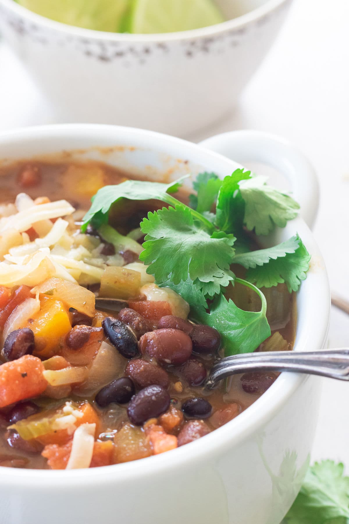 Closeup of a bowl of soup with black beans and cilantro.