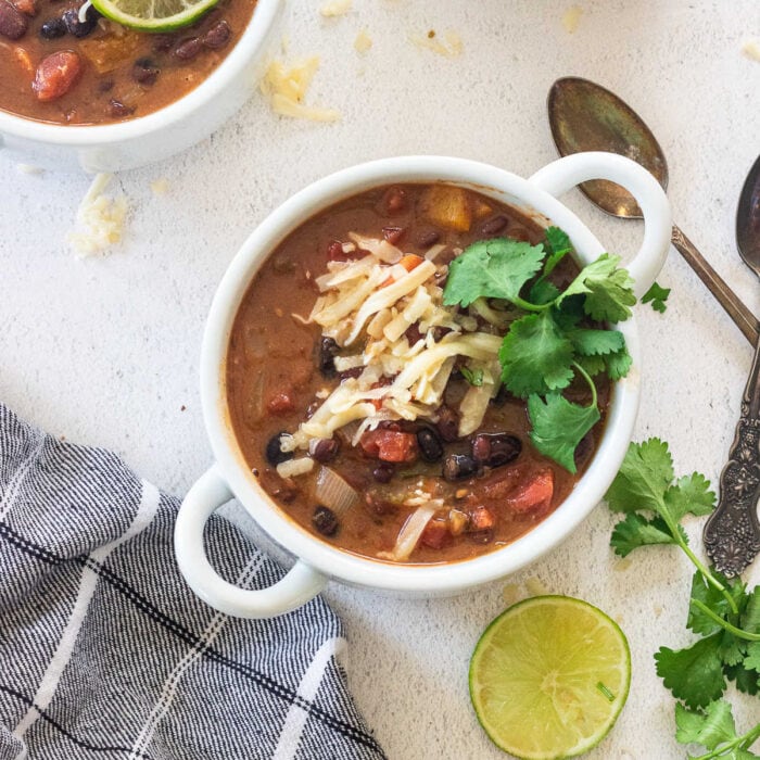 Overhead view of two bowls of black bean soup similar to paneras.