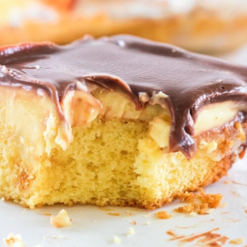 Close up of Boston cream cake showing the gooey ganache glaze.