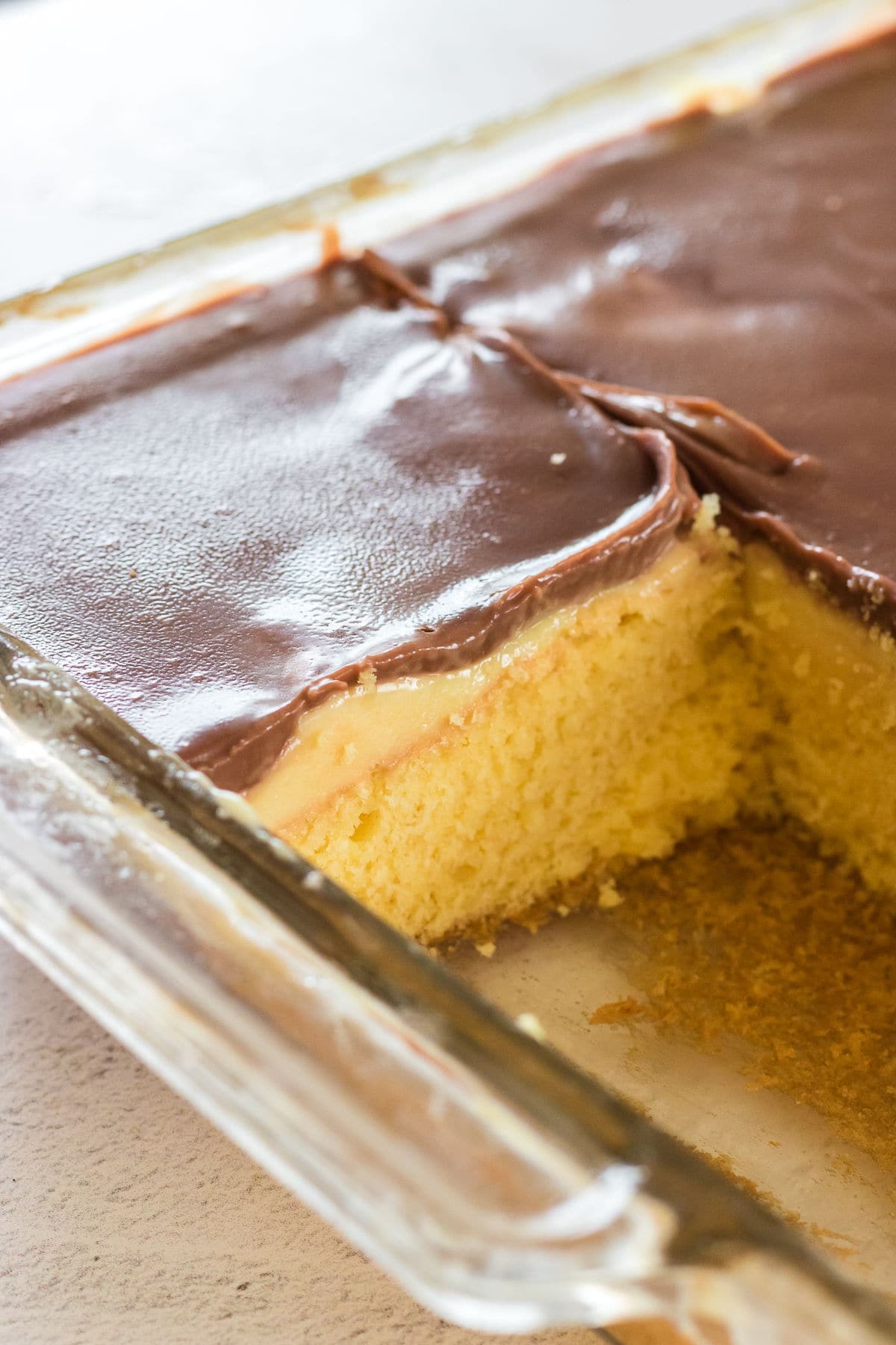 Close up of the cake in the baking pan with one serving removed.