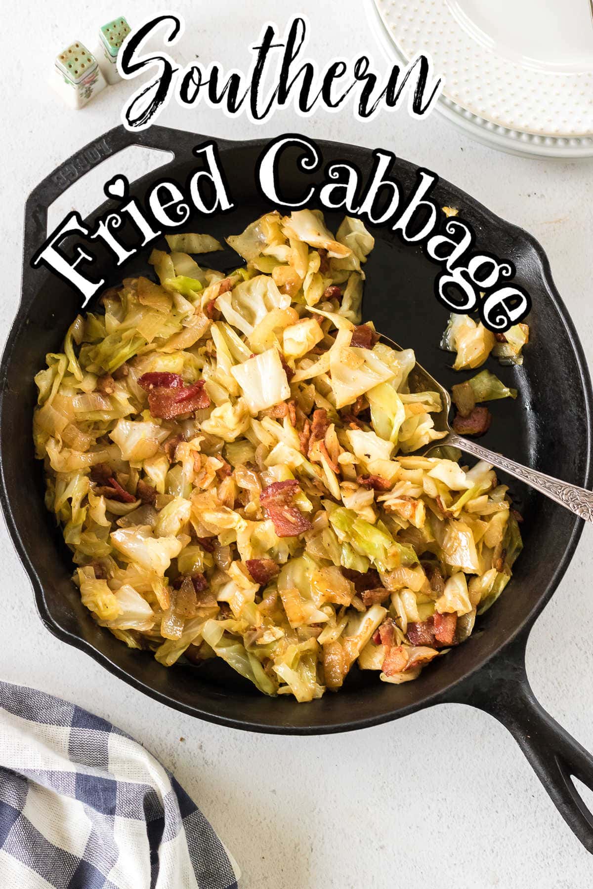 Overhead view of fried cabbage in a skillet with title text overlay.