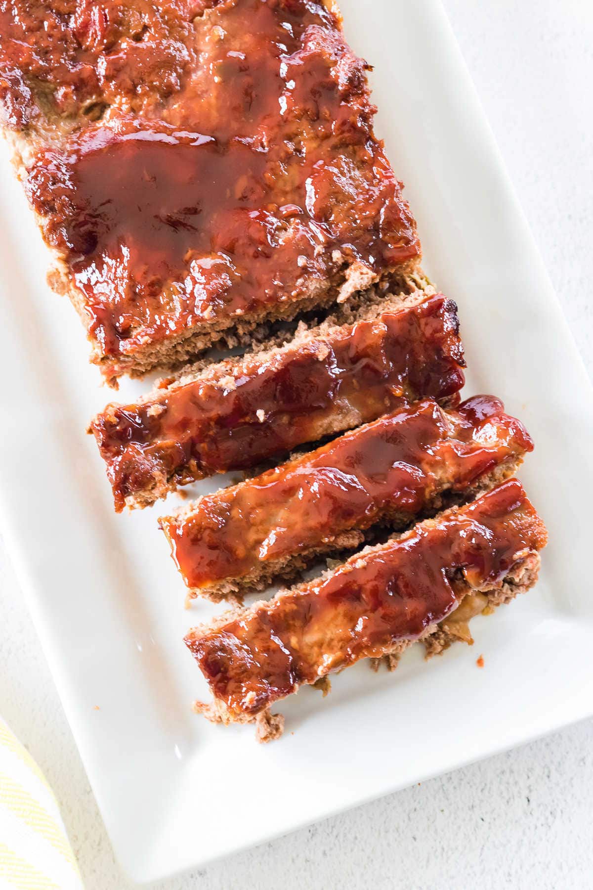 Overhead view of sliced, glazed meatloaf.