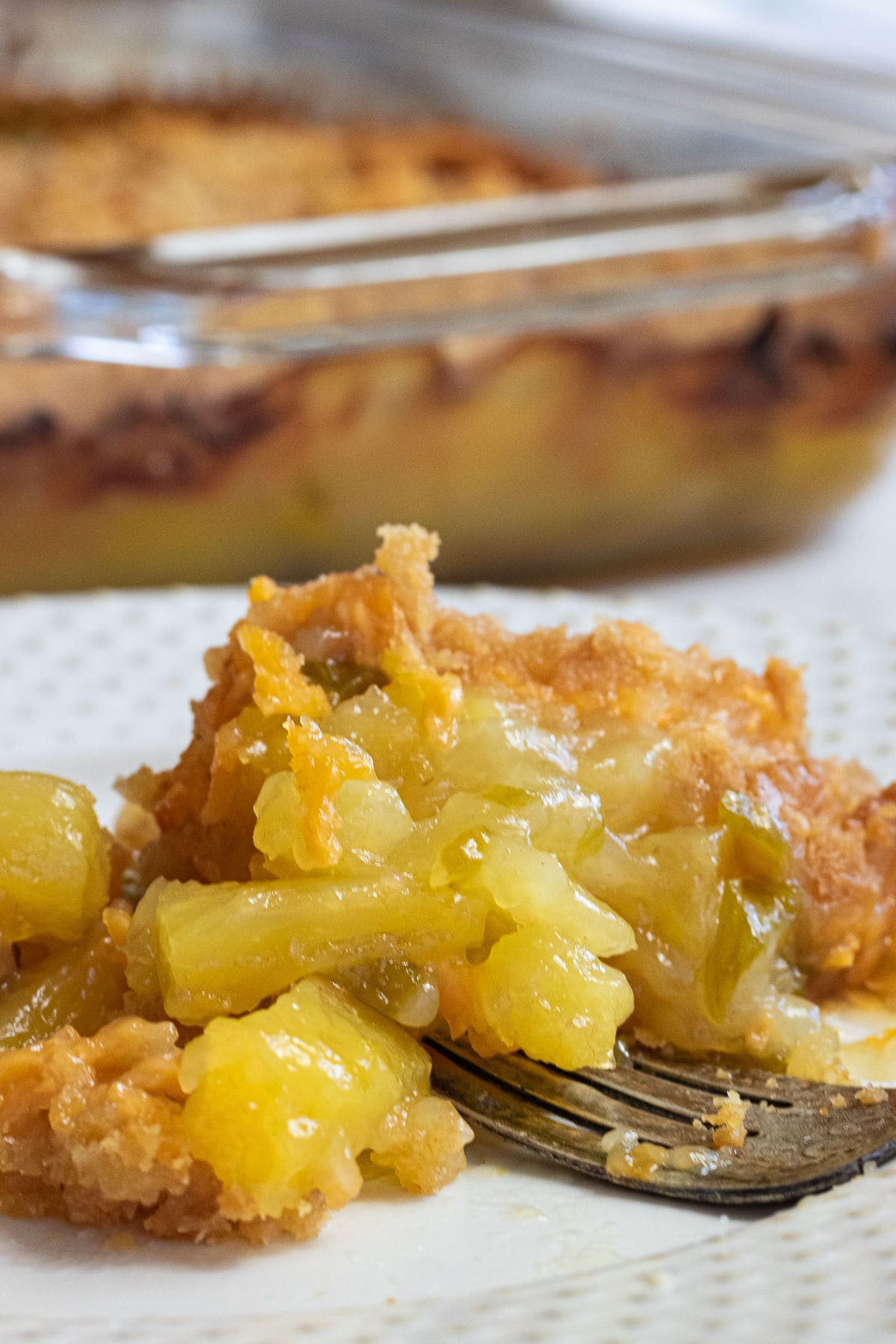 Close up of a serving of pineapple and cheese casserole.