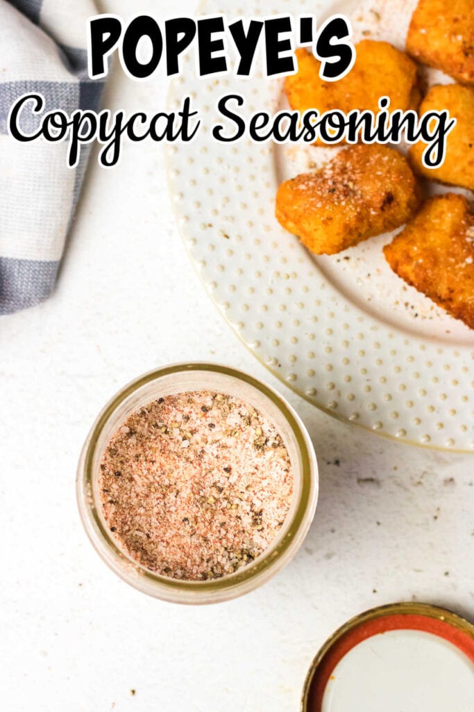 Overhead view of  seasoning mix in a jar with chicken nuggets in the background.