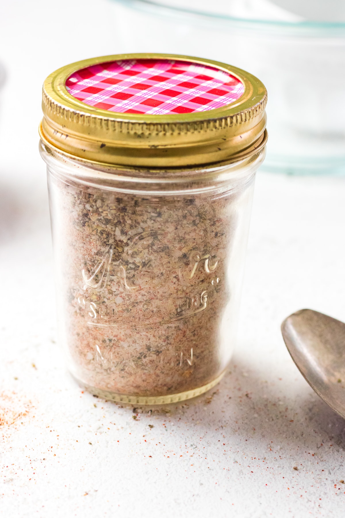 A small jelly jar with seasoning salt in it.