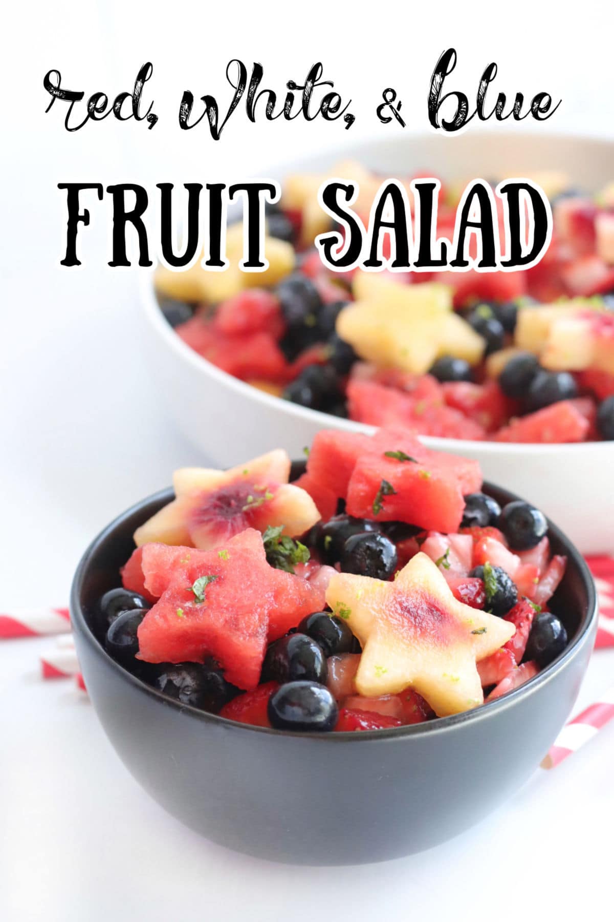 Side view of a bowl with watermelon, peaches, and blueberries. A title text overlay says red white and blue fruit salad.
