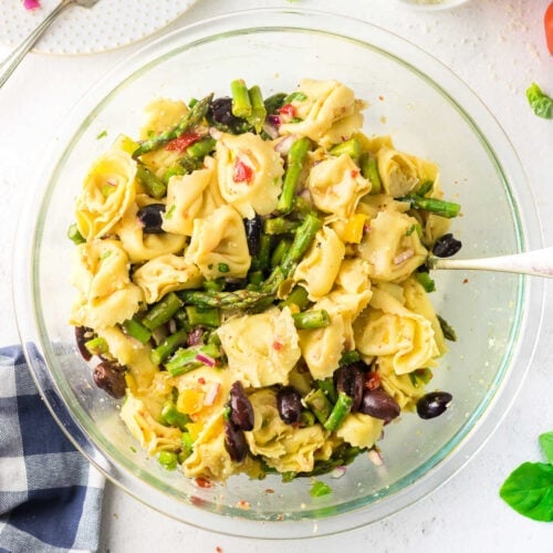 Overhead view of Italian cheese tortellini salad with asparagus.