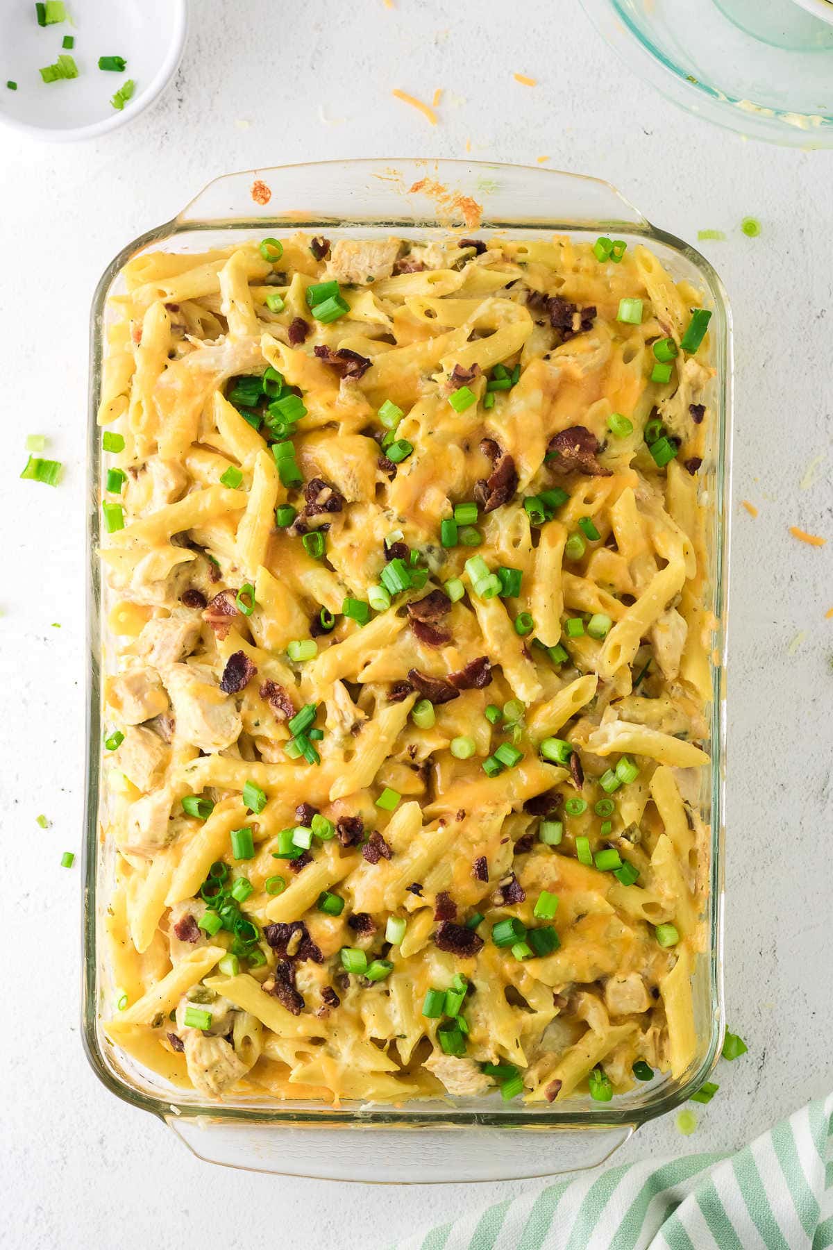 Overhead view of the chicken casserole garnished with bacon and green onions.