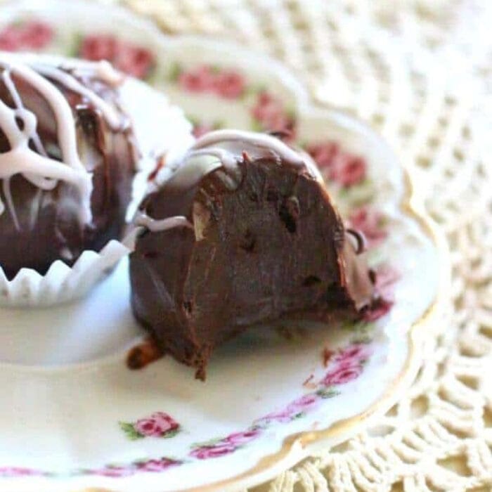 A chocolate truffle on a plate with a bite removed to