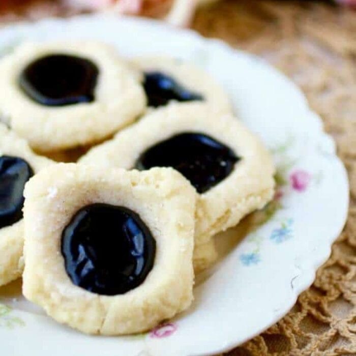 A plate of cookies with chocolate filled centers.