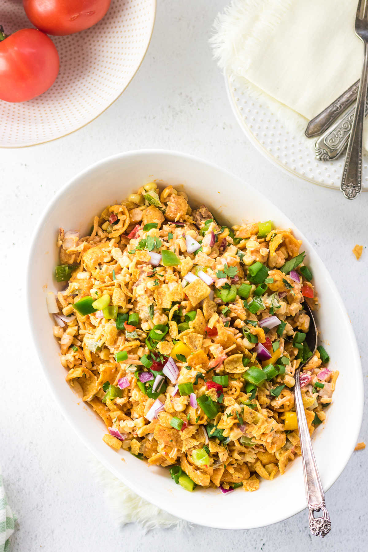 Overhead view of a white serving bowl of Frito corn salad.