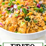 Bowl of Frito salad with a text overlay for Pinterest.