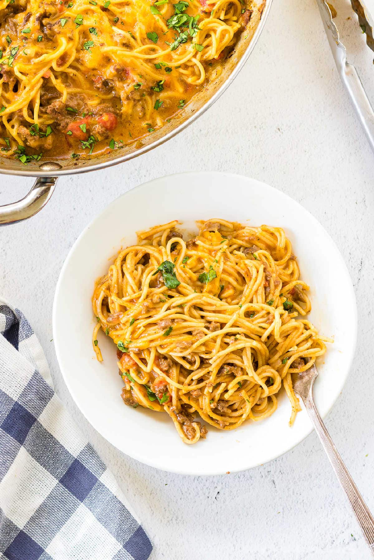 Overhead view of a white plate with a serving of taco spaghetti on it.