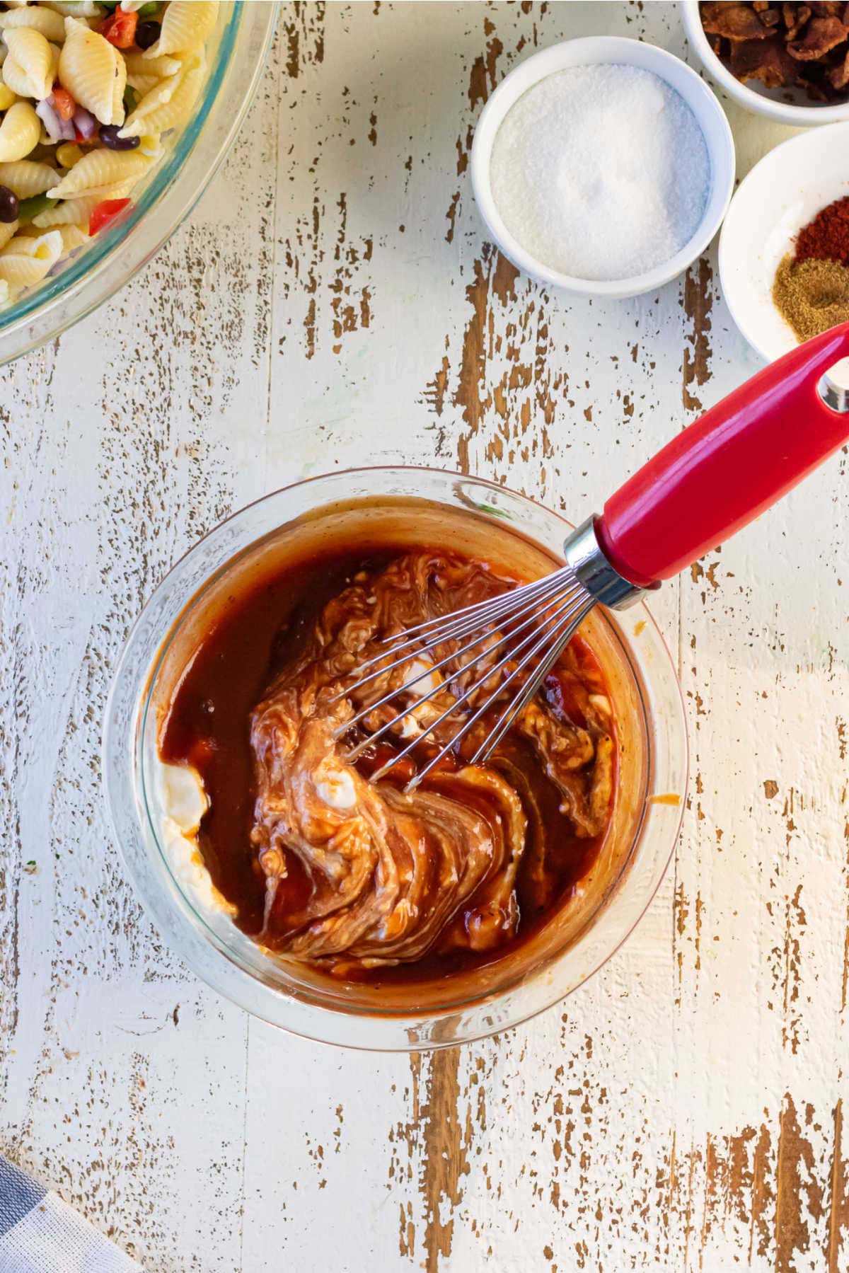 Dressing ingredients being mixed smooth with a whisk.