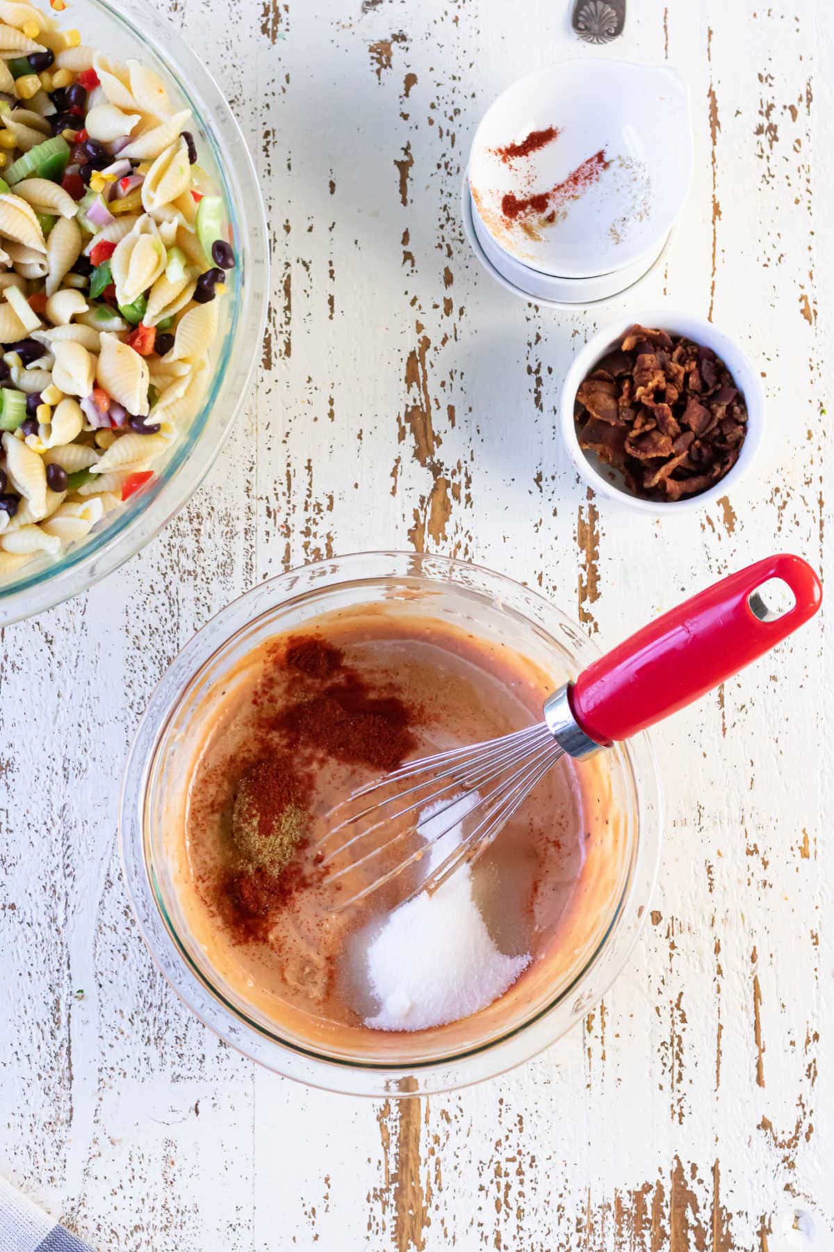 The ingredients for the dressing added to a bowl.