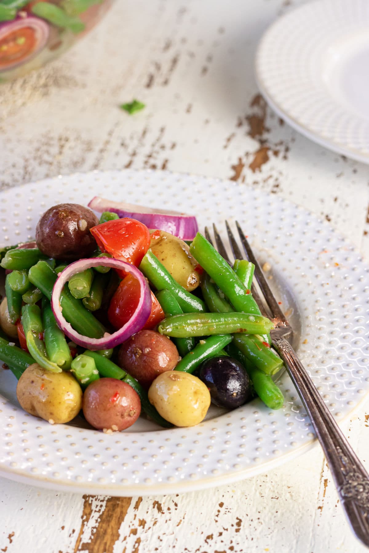 Decorative image. Close up of a plate of the salad with a fork in it.