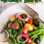 Overhead view of a plate of salad with title text overlay for Pinterest.