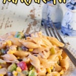 Side view of a plate of bbq pasta salad with text overlay for Pinterest.