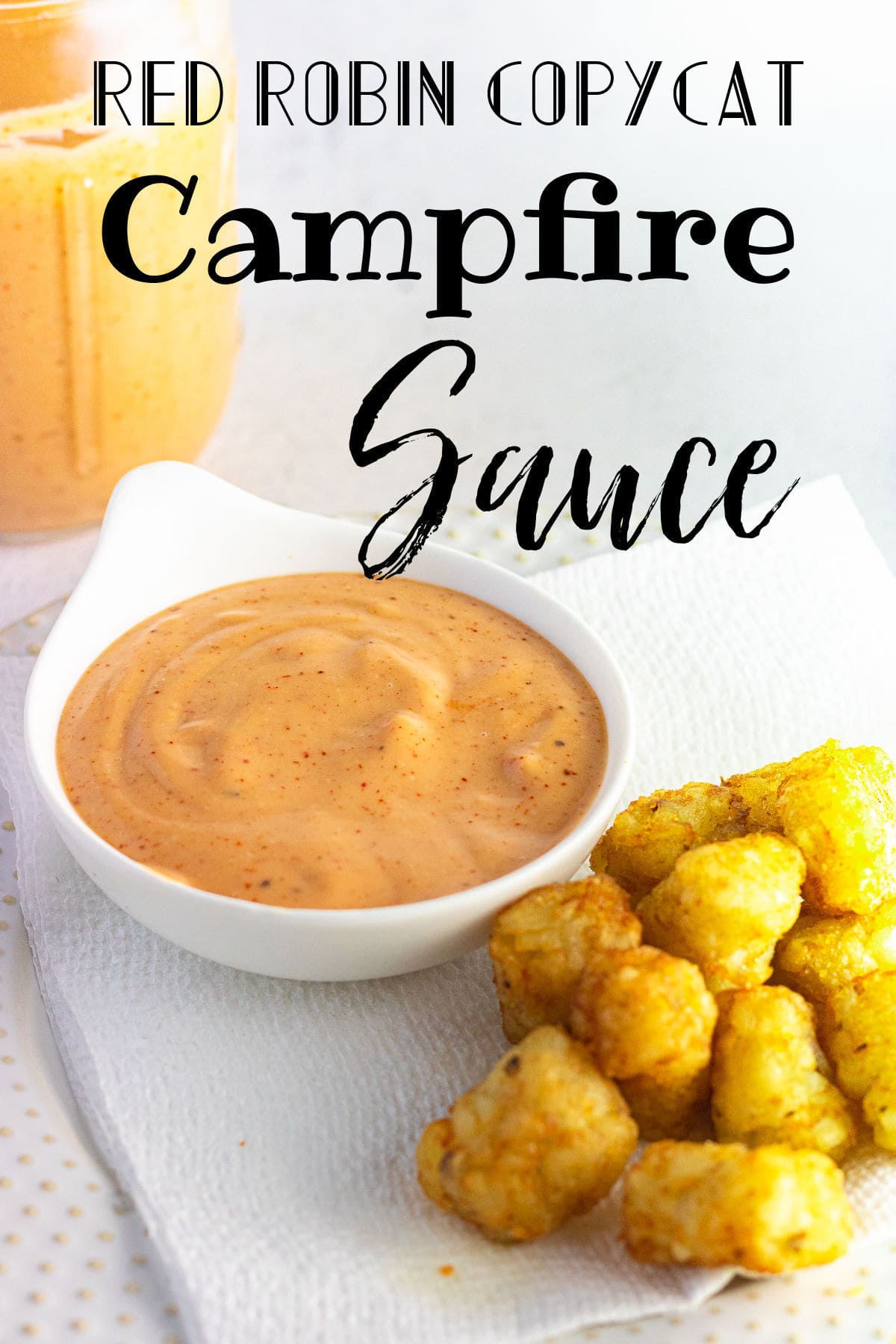 The orange dipping sauce in a bowl on a table.