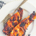 Overhead view of chicken breast on a plate. Title text overaly says "Grilled BBQ Chicken". Image created for pinning to Pinterest.