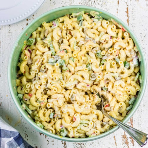 Over head view of macaroni salad with a spoon in it for the feature image.