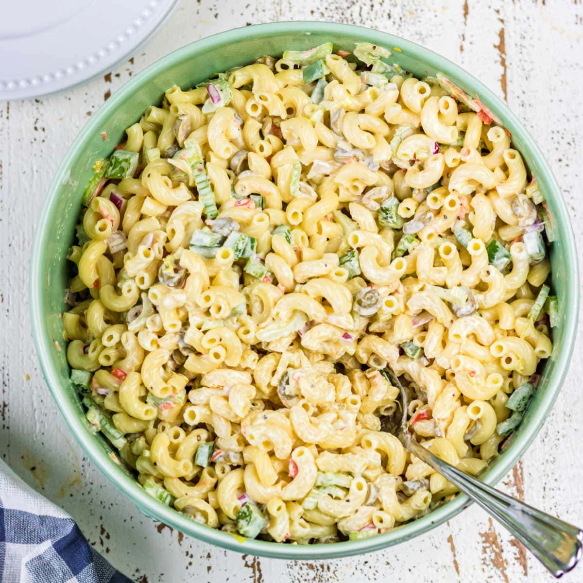 Over head view of macaroni salad with a spoon in it for the feature image.