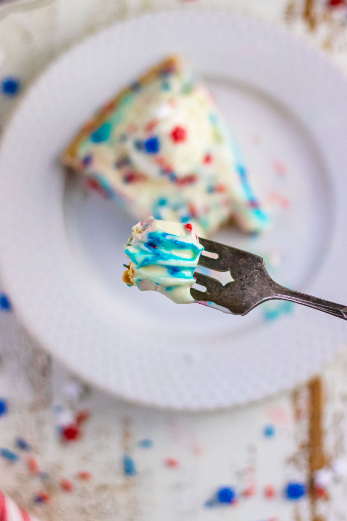 Decorative image. Overhead view of a forkful of dessert being lifted up.