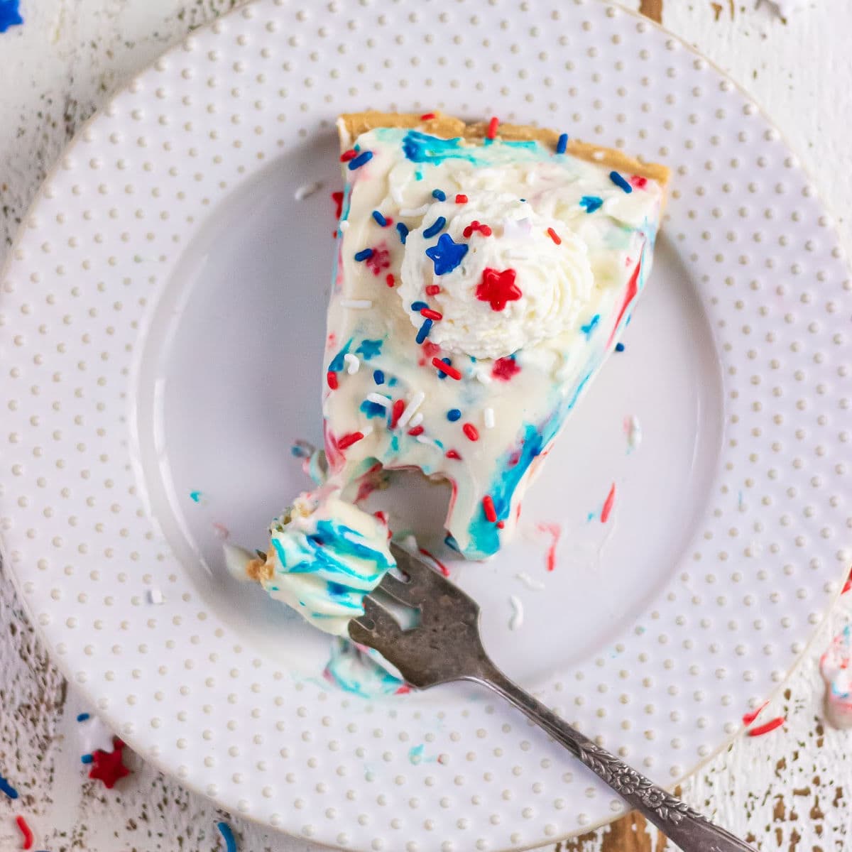 Overhead view of a slice of the finished pie garnished with red, white, and blue sprinkles.