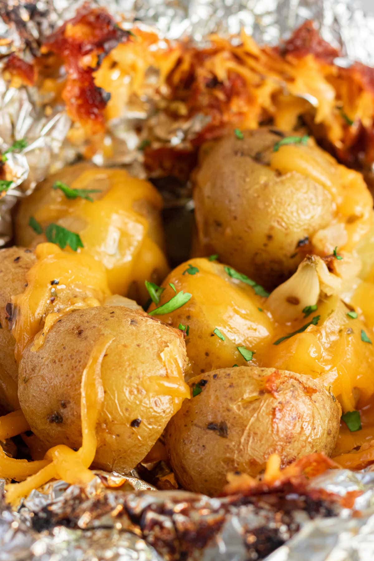 Open foil packet with cooked Yukon Gold potatoes inside.