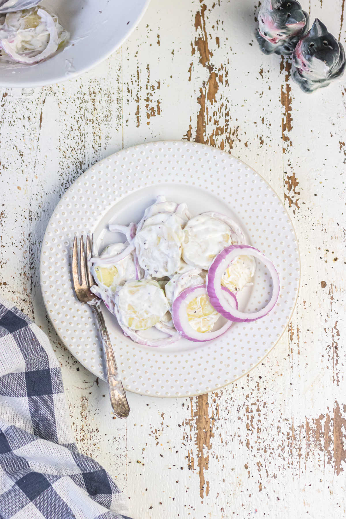 Decorative image. Overhead view of creamy cucumber salad on a plate.